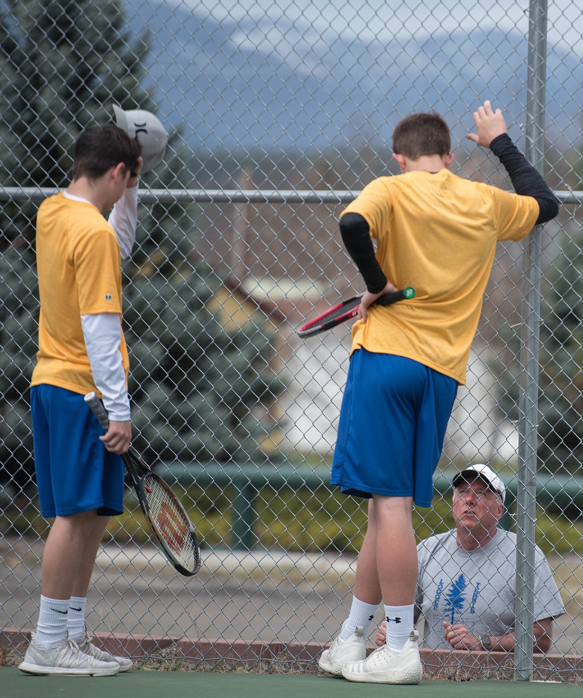 Colton Halvorson, left, and Cayman Lee listen to mid-game advice from coach Terry Oedewaldt in a game against Ronan, Thursday in Libby. (Luke Hollister/The Western News)