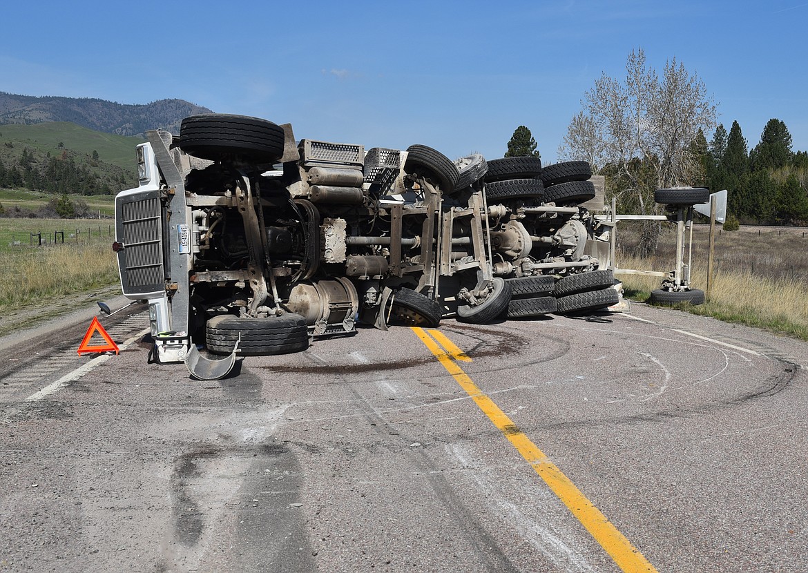 A CEMENT truck carrying a full load of seven yards of concrete overturned in the middle of Montana Highway 200 on Thursday morning, April 25 west of Dixon. Acccording to Montana Highway Patrol Trooper T.R. Rosenbaum, the driver lost control during dry conditions and was not injured. No other vehicles were involved. (Carolyn Hidy photos/Clark Fork Valley Press)