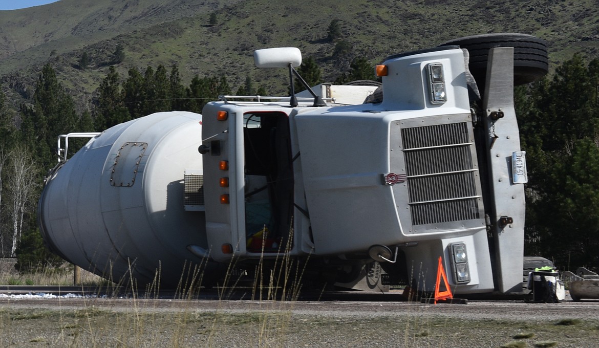 WHILE THE overturned truck blocked both lanes of travel on the two-lane roadway, traffic was diverted around the wreck of the shoulder of Highway 200.