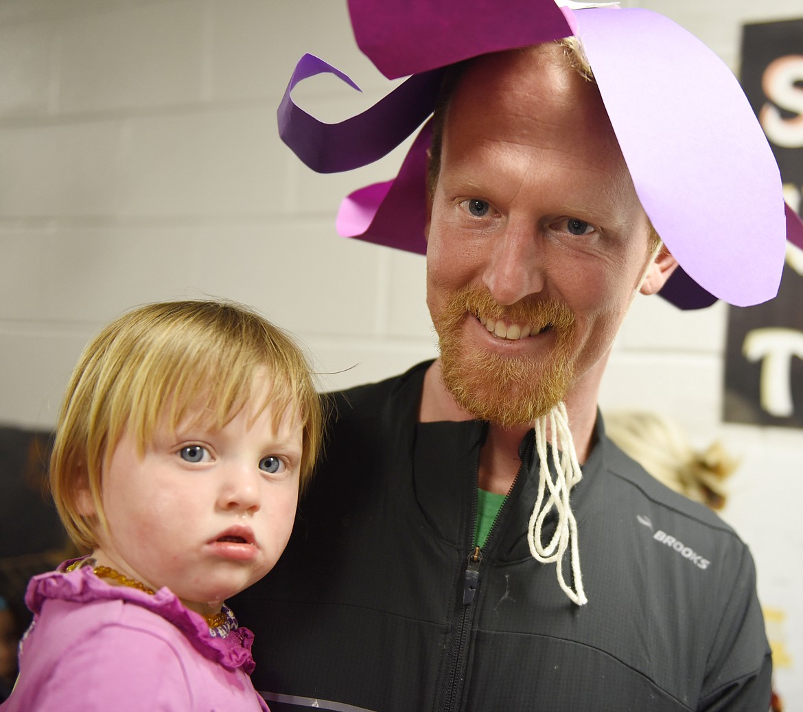 LOU BRENNER and his daughter Asha enjoy Night of the Arts activities at Cherry Valley Elementary, such as making fancy hats like the one worn by dad.