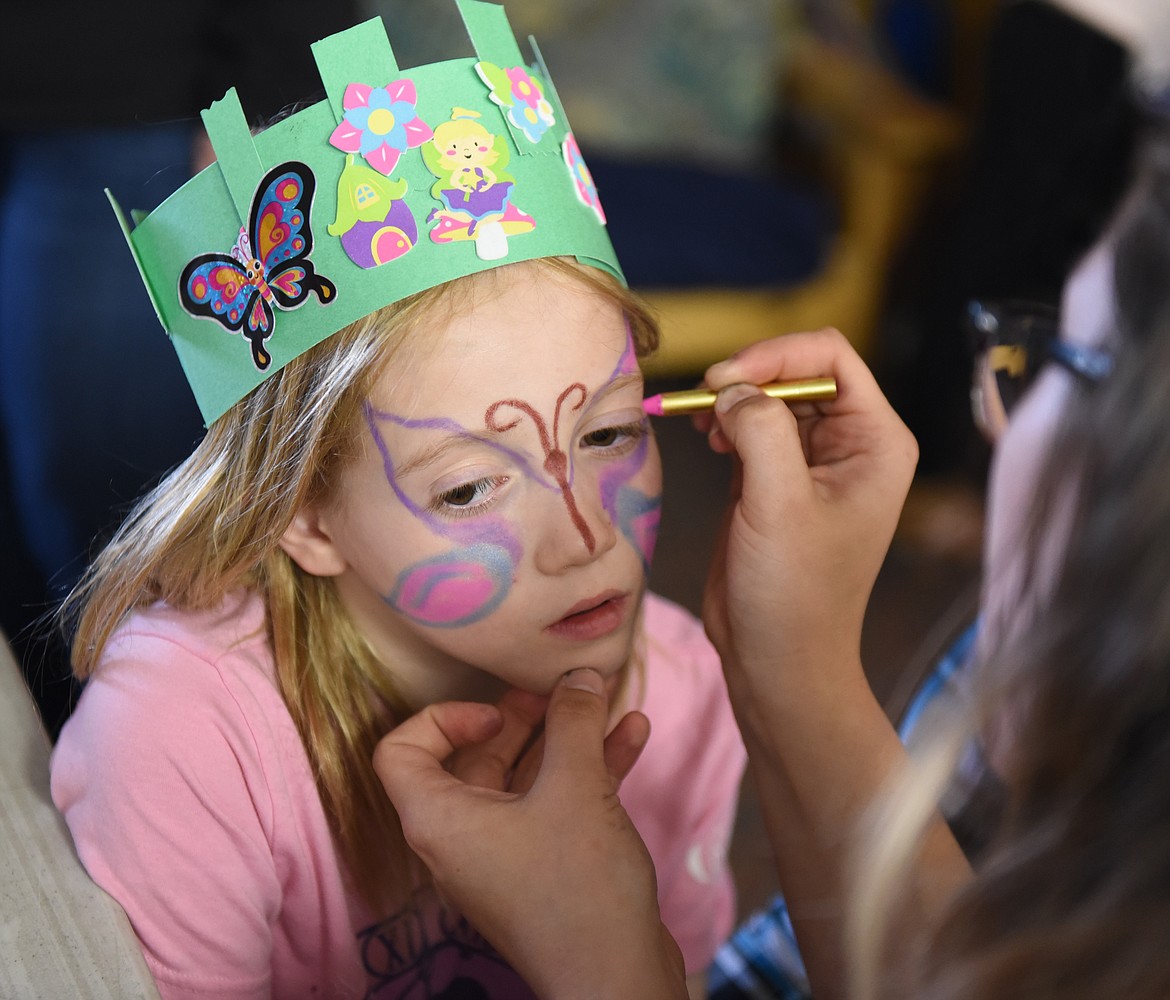 ADI MONTGOMERY patiently waits for her face to be painted during Night of the Arts activities held Thursday, April 18 at Cherry Valley Elementary in Polson. Many of the kids who attended the event were pre-schoolers who joined in on a spring celebration of the artistic talents of youngsters from toddlers to elementary school age.



 (Joe Sova photos/Lake County Leader)