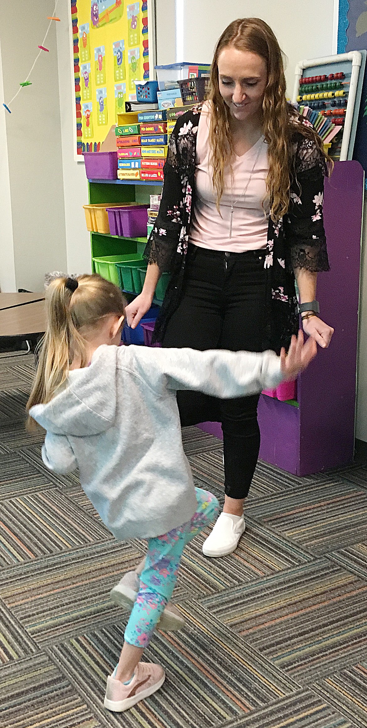KYRIE CARR, 5, enjoys the challenge posed by kindergarten teacher Dani Walker during the registration process activities on April 19 at Plains School.