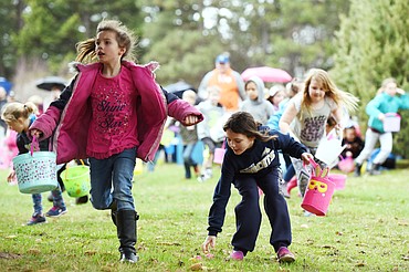Kids race to scoop up eggs at the North Valley Eagles No. 4081 Easter egg hunt at Marantette Park in Columbia Falls. (Casey Kreider/Daily Inter Lake)