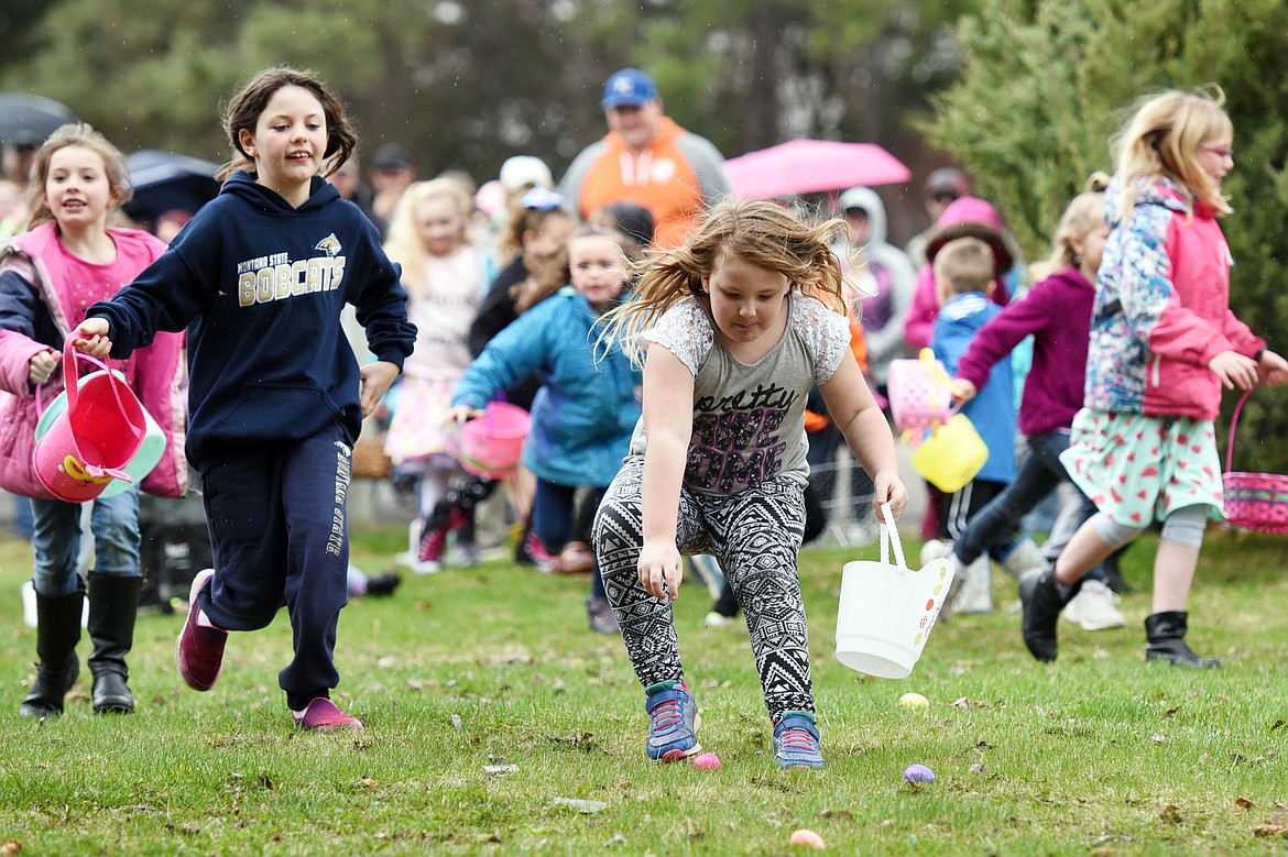 Kids race to scoop up eggs at the North Valley Eagles No. 4081 Easter egg hunt.