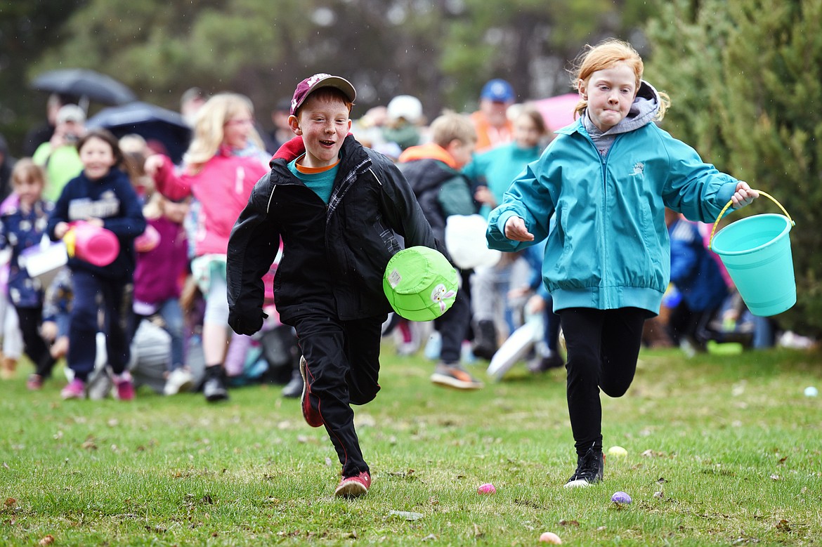 Kids race to scoop up eggs at the North Valley Eagles No. 4081 Easter egg hunt at Marantette Park in Columbia Falls on Saturday. (Casey Kreider/Daily Inter Lake)