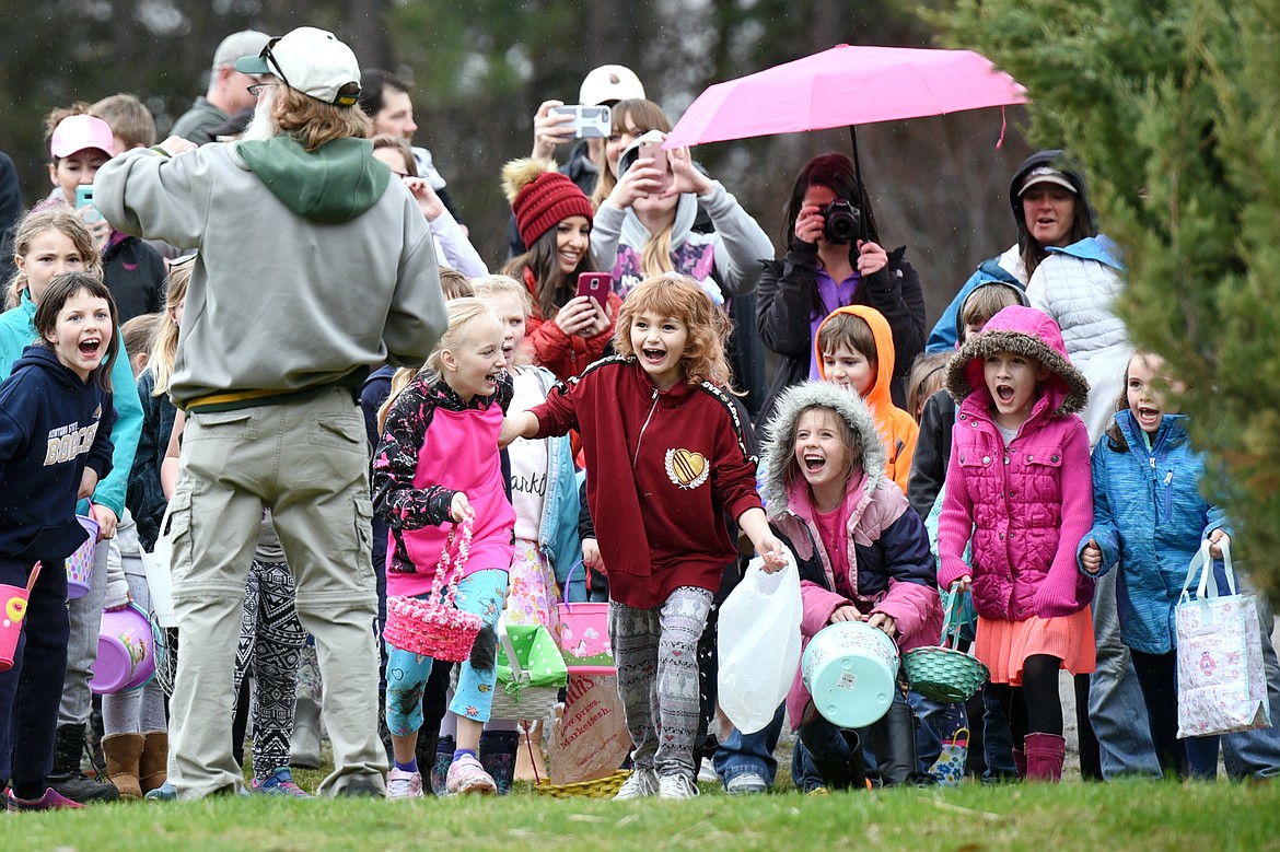 Children count down with Larry Netzel, left, to start the egg hunt at Marantette Park.