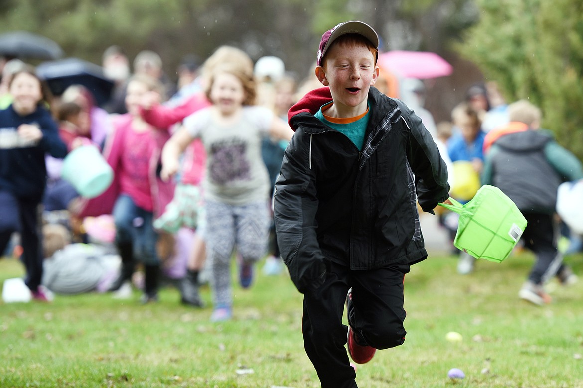 Kids race to scoop up eggs at the North Valley Eagles No. 4081 Easter egg hunt at Marantette Park in Columbia Falls on Saturday. (Casey Kreider/Daily Inter Lake)