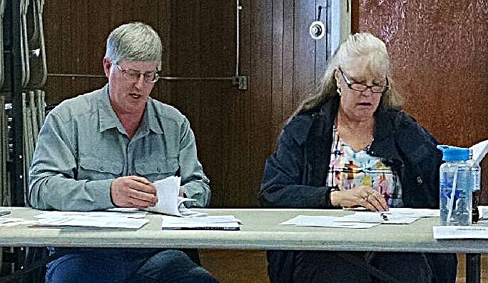 SANDERS COUNTY Fair Board chairman Randy Woods and board member Roberta Smith look over items of business during the monthly Fair Board meeting Wednesday, April 17 in Plains. (Courtesy photo)