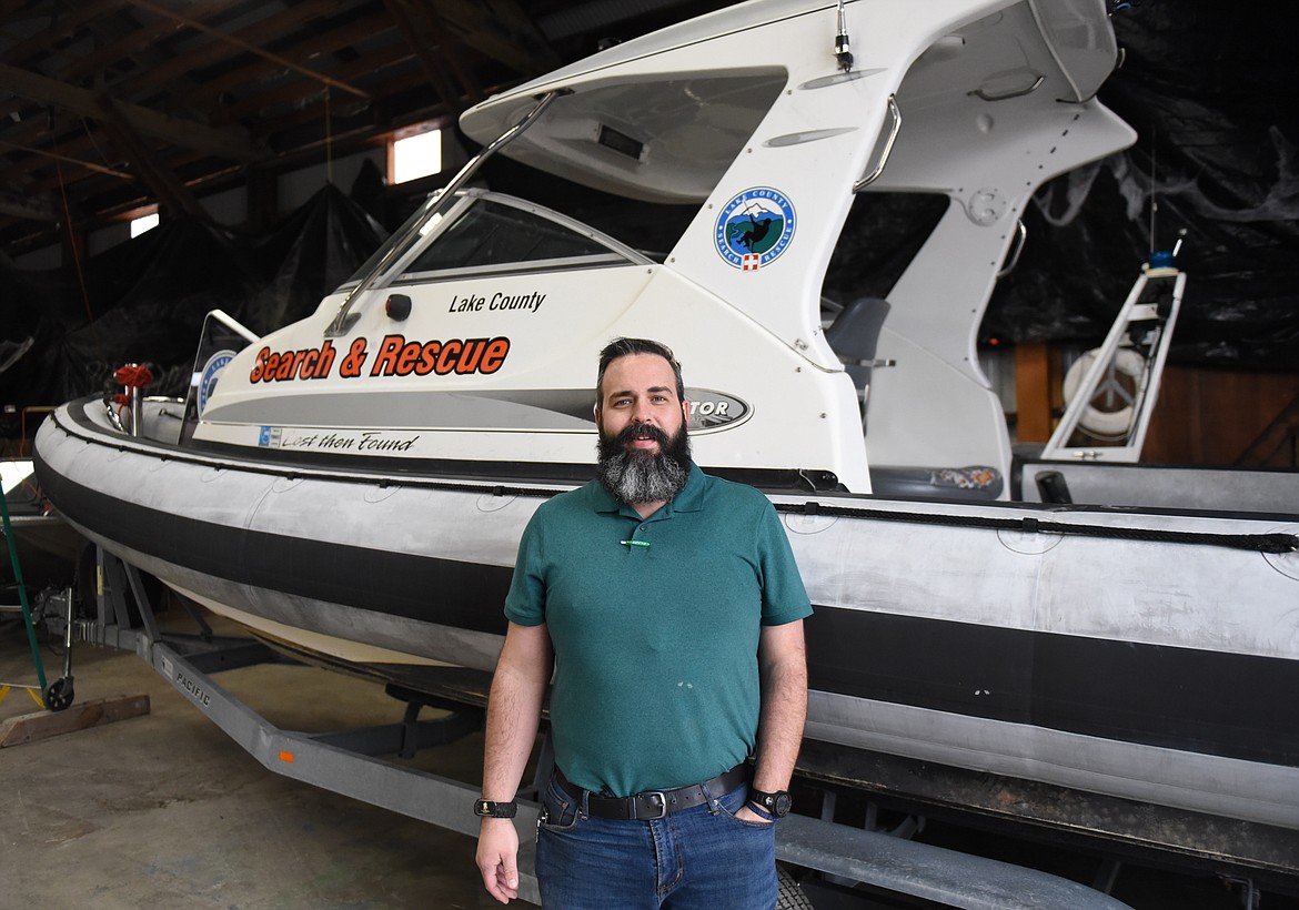 LAKE COUNTY Search and Rescue President Jared Bell stands in front of the boat used on Flathead Lake in time of need. It has a double-250hp prop powerhouse to propel the vessel, a V hull and raft-like inflated sides, front and back. (Joe Sova photos/Lake County Leader)