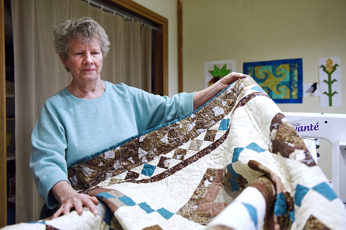Ellen Metzger displays a quilt she created to raffle off in support of the Flathead Valley Parkinson's Support Group at her home in Kalispell on Wednesday, April 17. (Casey Kreider/Daily Inter Lake)