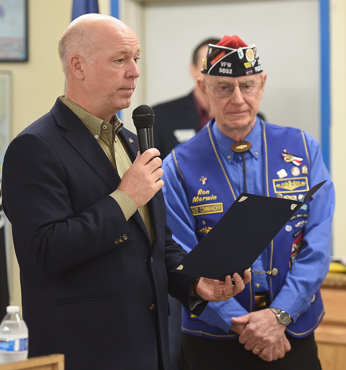 U.S. REP. Greg Gianforte reads the verbiage in the Montana Congressional Veteran Commendation before presenting it to Ron Merwin, right, during the April 17 ceremony at the VFW in Ronan.