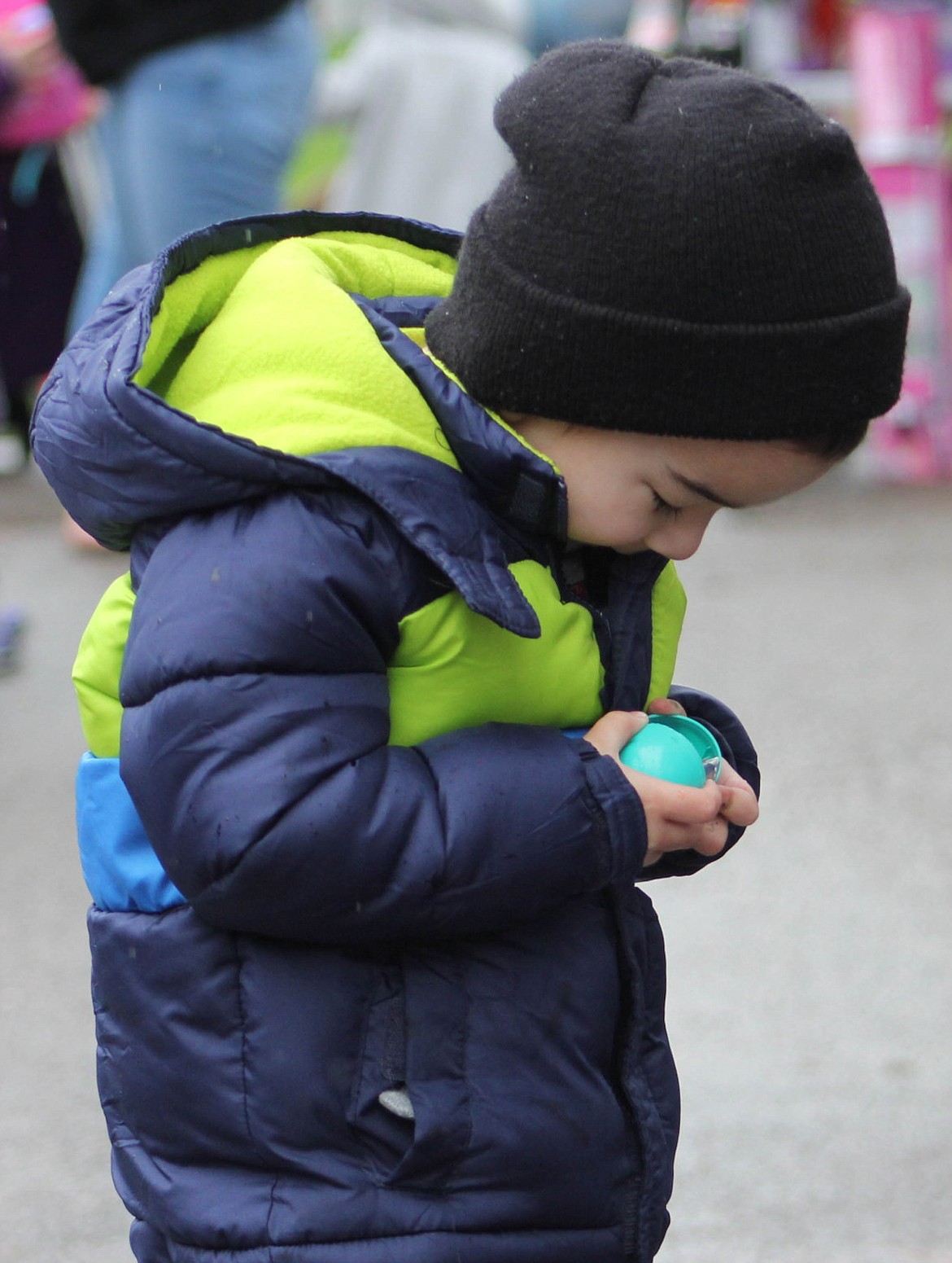 JOSEPH MANAGHAN, 4, opens his prize after Superior's Easter Egg Hunt at Eva Horning Park on Saturday, April 20. (Maggie Dresser/Mineral Independent)