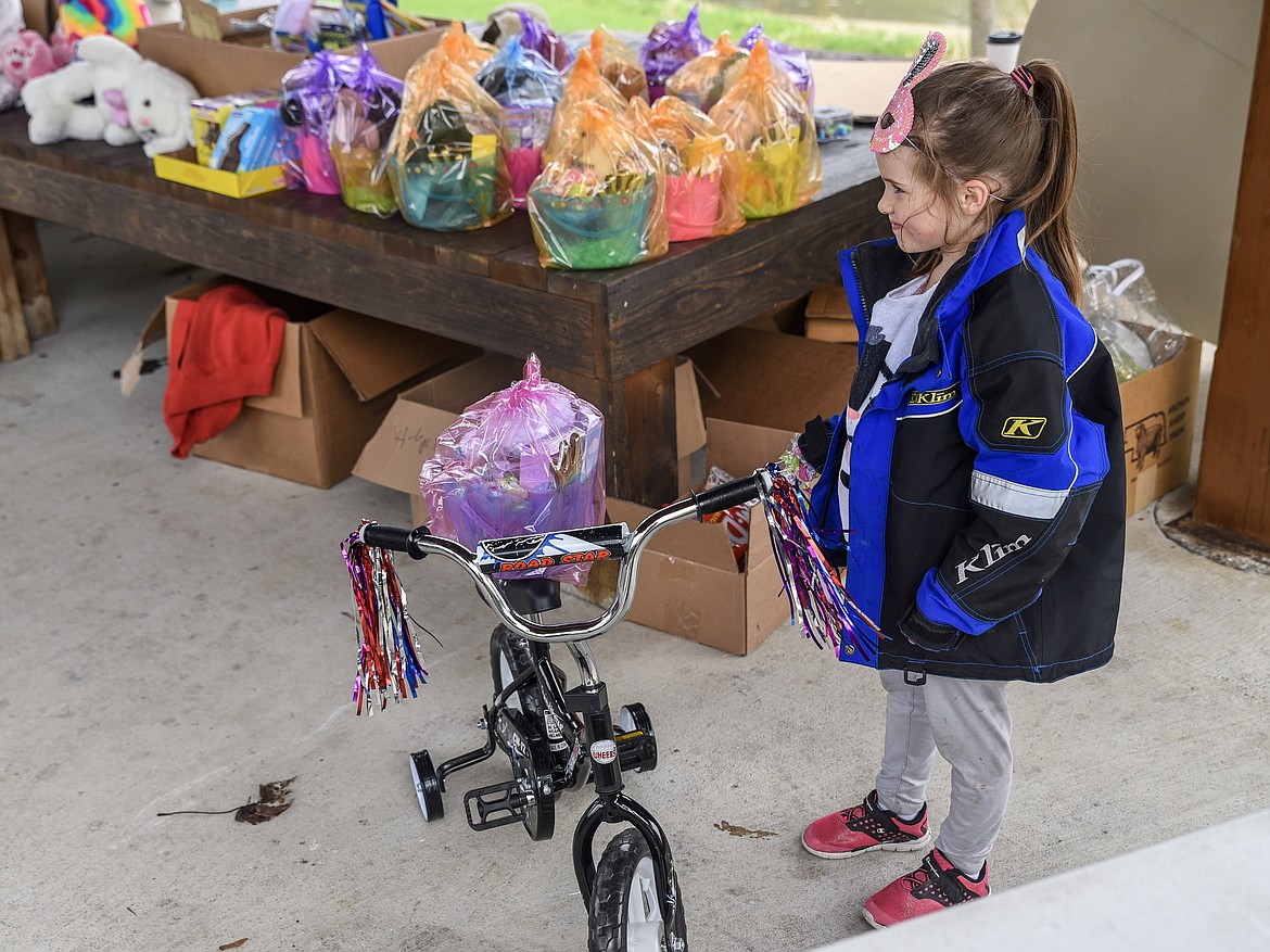 Lyric Stanton stands with the bicycle she won, and plans to donate to another child, at Roosevelt Park in Troy Saturday. (Ben Kibbey/The Western News)