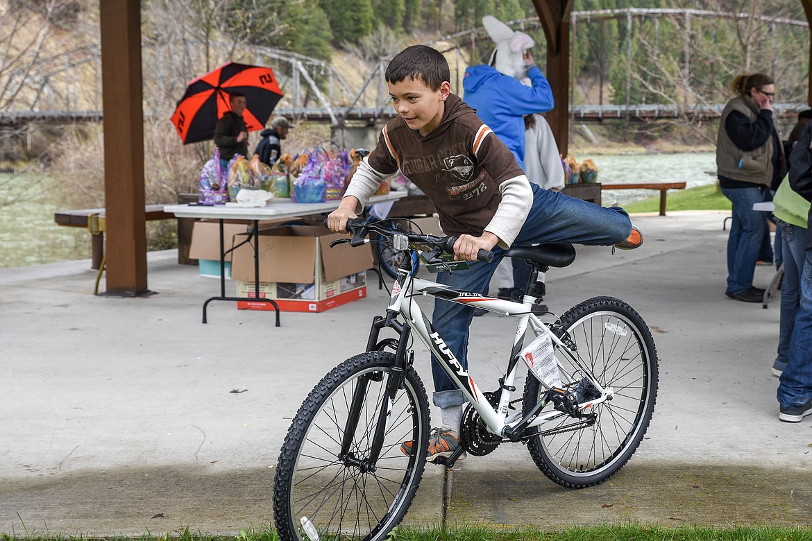 Nick Harper jumps on the bicycle he won from the Easter egg hunt at Roosevelt Park in Troy Saturday. (Ben Kibbey/The Western News)