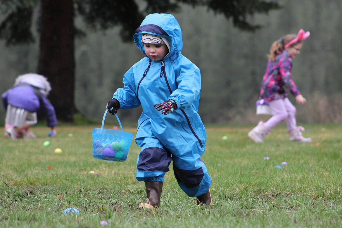 CYR RESIDENT Gage Spring, 3, runs through the rain to gather eggs at Alberton&#146;s Easter Egg Hunt on Saturday, April 20. (Maggie Dresser/Mineral Independent)