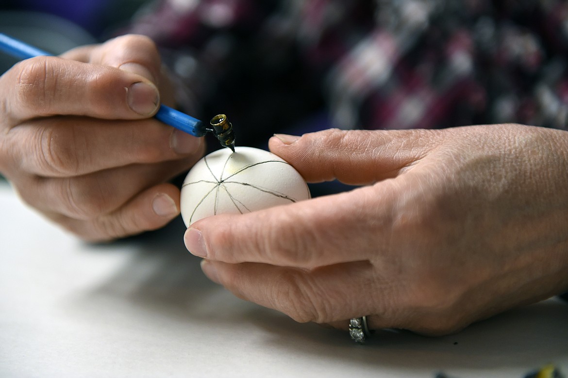 kathy Martin uses a kistka to draw a pattern in wax for a Ukrainian Easter egg.