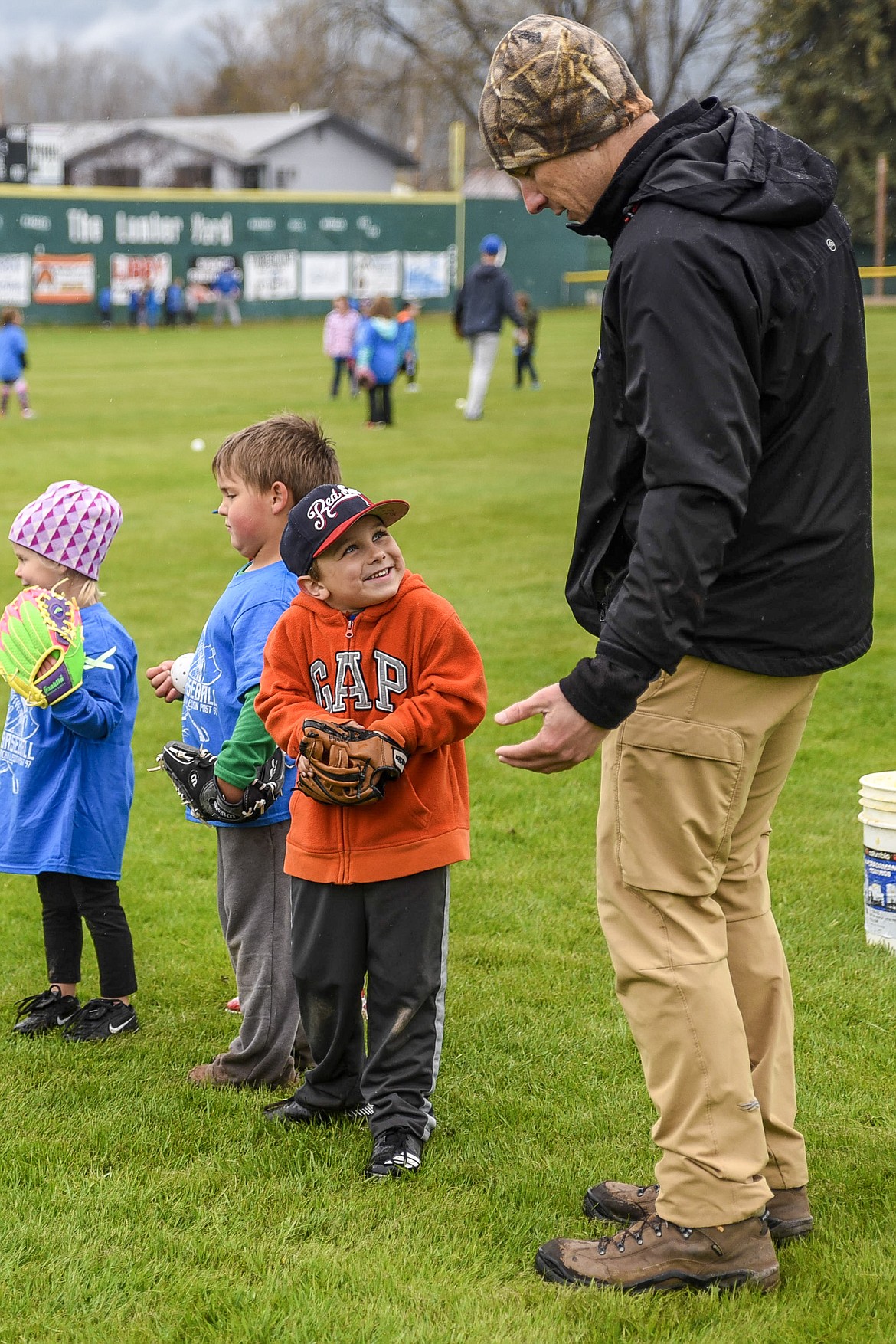 Benjamin Repine responds to his dad, Damon Repine, with a little uncertainty about whether he remembers how to field a ground ball at the Libby Loggers Kids Camp Saturday at Lee Gehring Field. (Ben Kibbey/The Western News)
