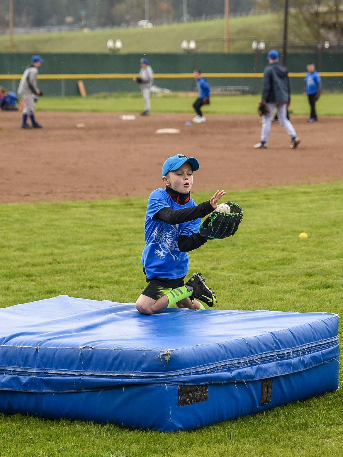 Hudson Hannah practices diving for a catch at the Libby Loggers Kids Camp Saturday at Lee Gehring Field. (Ben Kibbey/The Western News)