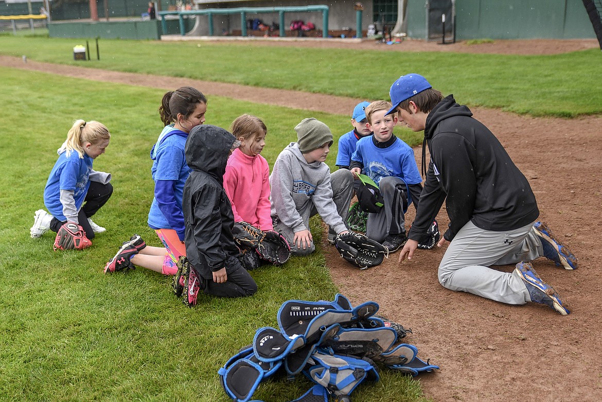 Quade Anderson works with campers on technique at the Libby Loggers Kids Camp Saturday at Lee Gehring Field. (Ben Kibbey/The Western News)