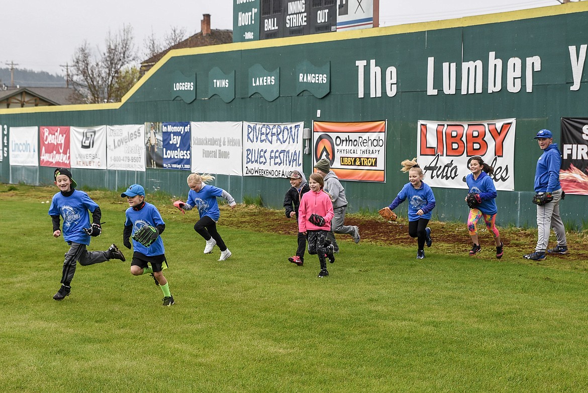 Campers make a mad dash to the next station at the Libby Loggers Kids Camp Saturday at Lee Gehring Field. (Ben Kibbey/The Western News)