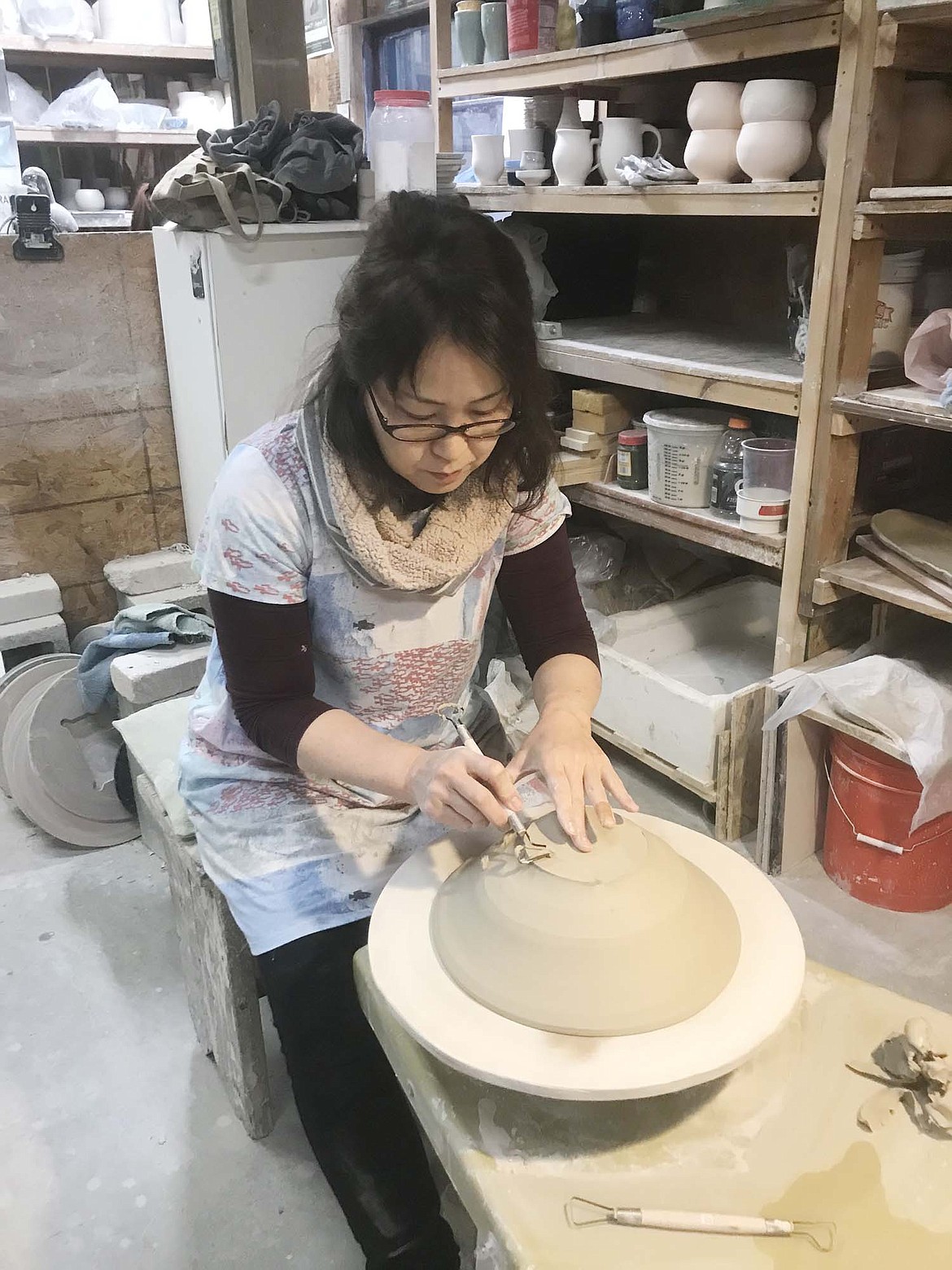 Potter Kazuyo Taguchi works on a piece at Whitefish Pottery Studios that was placed in a wood-fired kiln at the studio. She is one of three Japanese pottery artists who will have work on display at Whitefish Pottery and Stillwater Gallery during the month of May. (Courtesy photo)