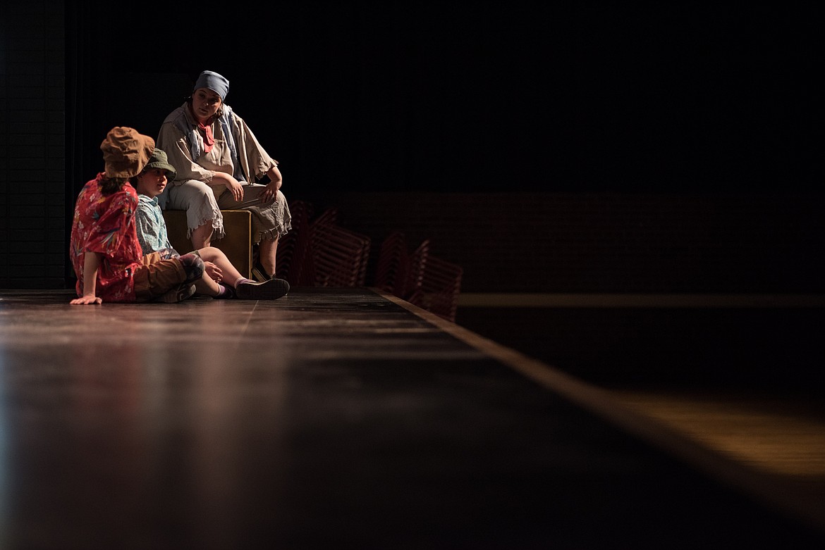 Airyana (left) and Mercedes Haugen, both acting as “beach bums,” listen to Sarah Price, as Jolly Roger, tell a story about hidden treasure, while performing Blackbeard the Pirate, Saturday at the Libby Memorial Events Center. (Luke Hollister/The Western News)