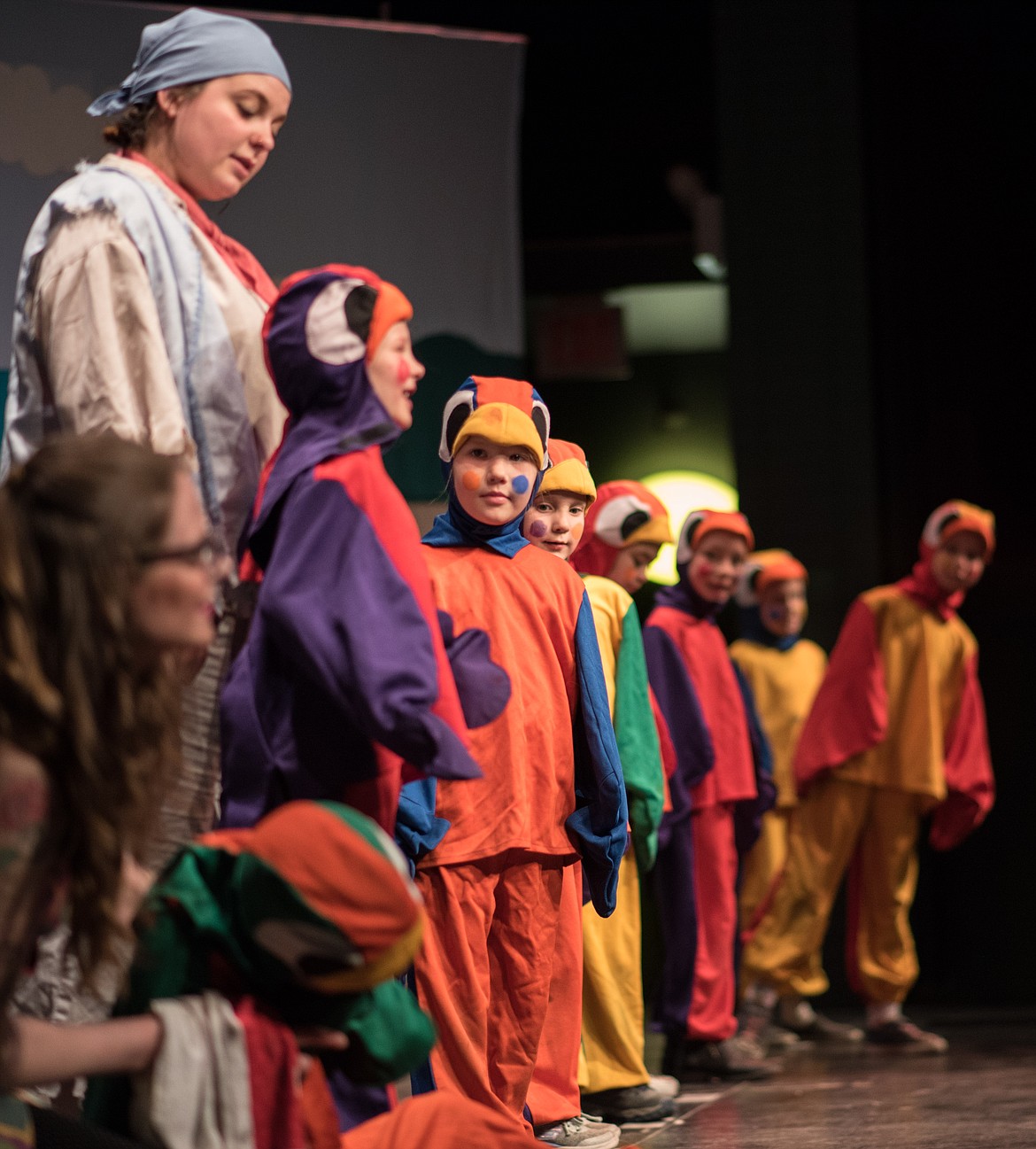 Children dressed as parrots fill the stage floor performing Blackbeard the Pirate, Saturday at the Libby Memorial Events Center. (Luke Hollister/The Western News)