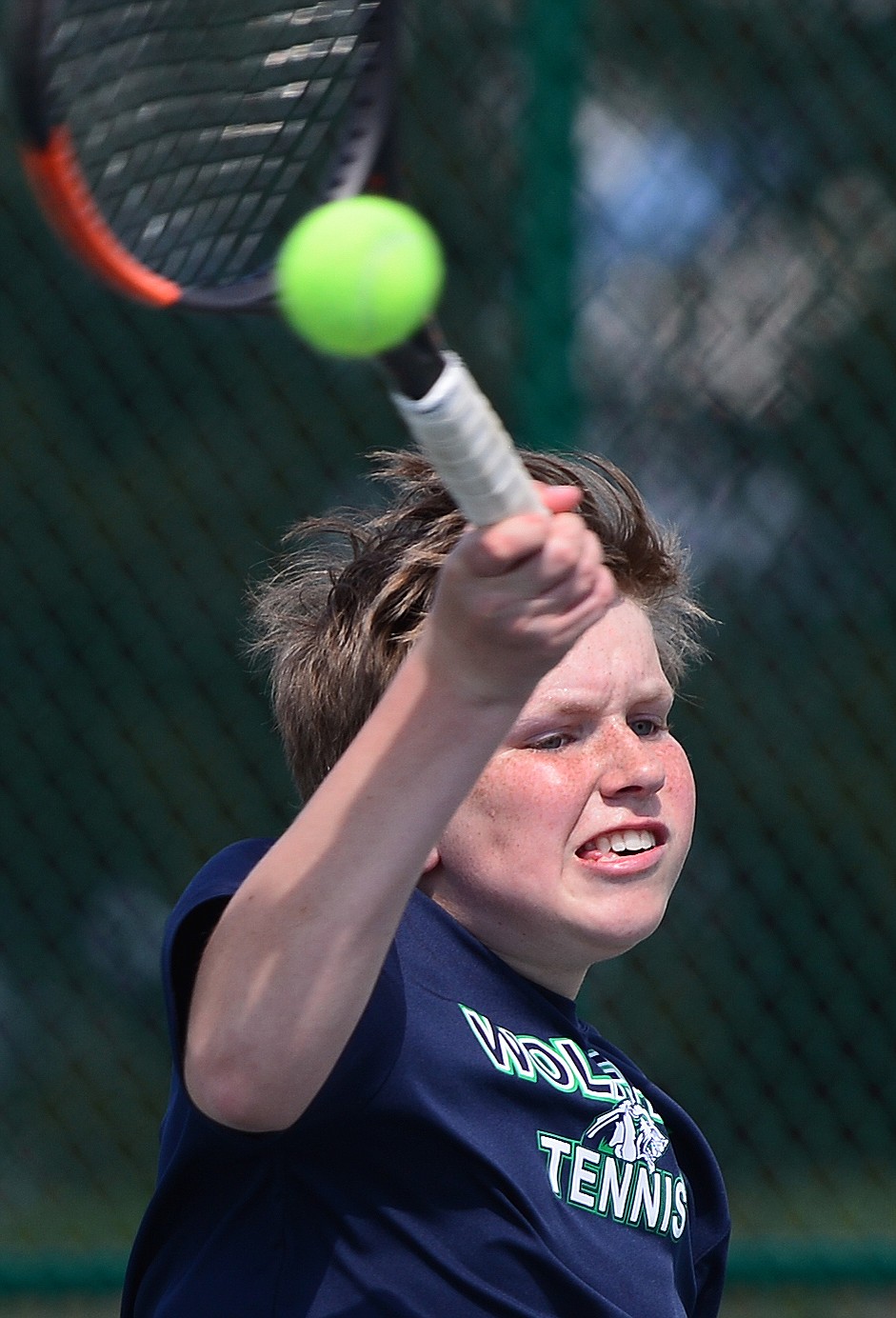 Glacier's Rory Smith hits a return against Flathead's Brett Thompson during crosstown tennis at Flathead Valley Community College on Tuesday. (Casey Kreider/Daily Inter Lake)