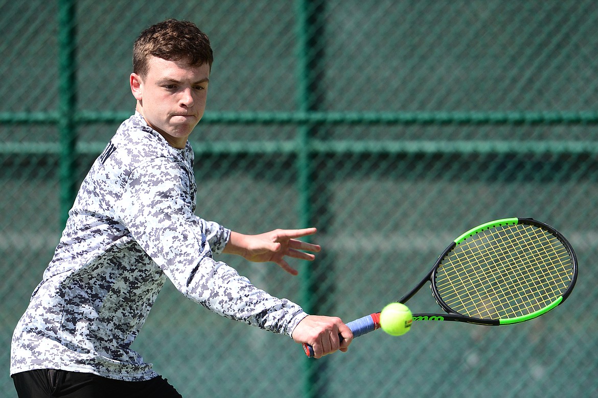 Flathead's Brett Thompson hits a return against Glacier's Chris Skelton during crosstown tennis at Flathead Valley Community College on Tuesday. (Casey Kreider/Daily Inter Lake)