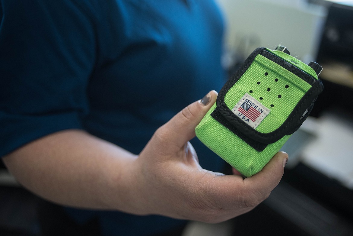 Amy Milde shows the radio she uses when being called in, Monday at the Libby Volunteer Ambulance building. &#147;I pretty much have the radio with me all the time,&#148; she said. (Luke Hollister/The Western News)