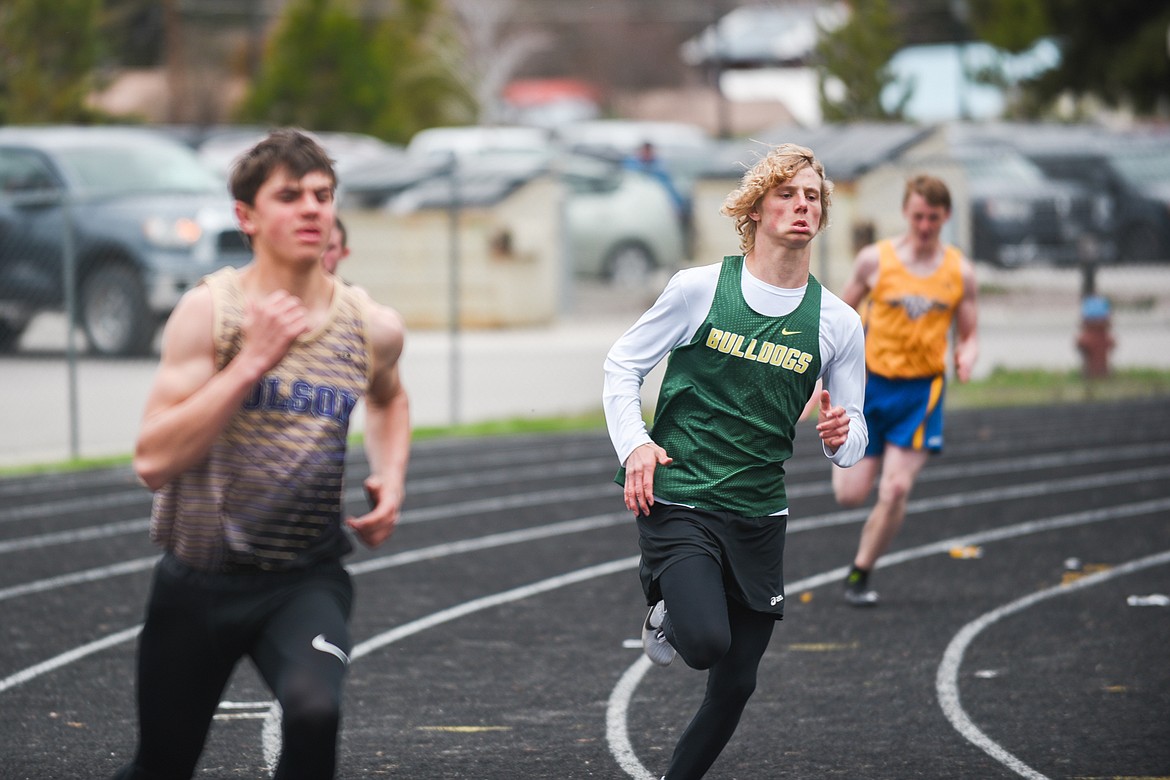 Josh Dudley rounds the first turn of the 400 meter dash during the Akey, Rosenburg, Murphy Invitational Saturday at Whitefish High School.