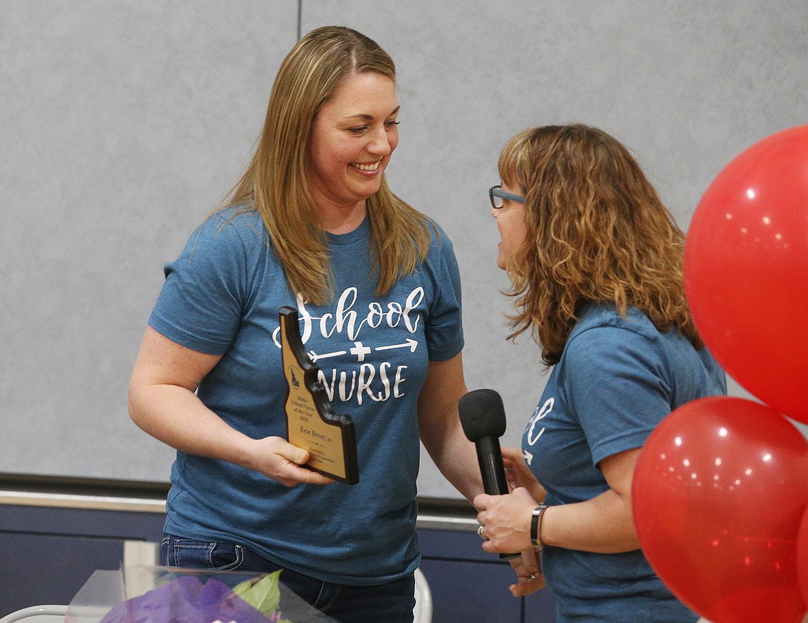 Erin Dever accepts the Idaho Nurse of the Year Award from lead Coeur d'Alene School District nurse Nichole Piekarski Wednesday at Skyway Elementary School. (LOREN BENOIT/Press)