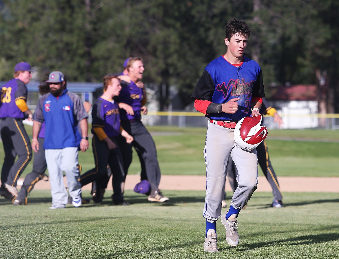 LOREN BENOIT/Press 
Coeur d&#146;Alene baserunner Jake Brown jogs back to the dugout as Lewiston celebrates its 5A Region 1 championship win over the Vikings on Tuesday at Coeur d&#146;Alene High.