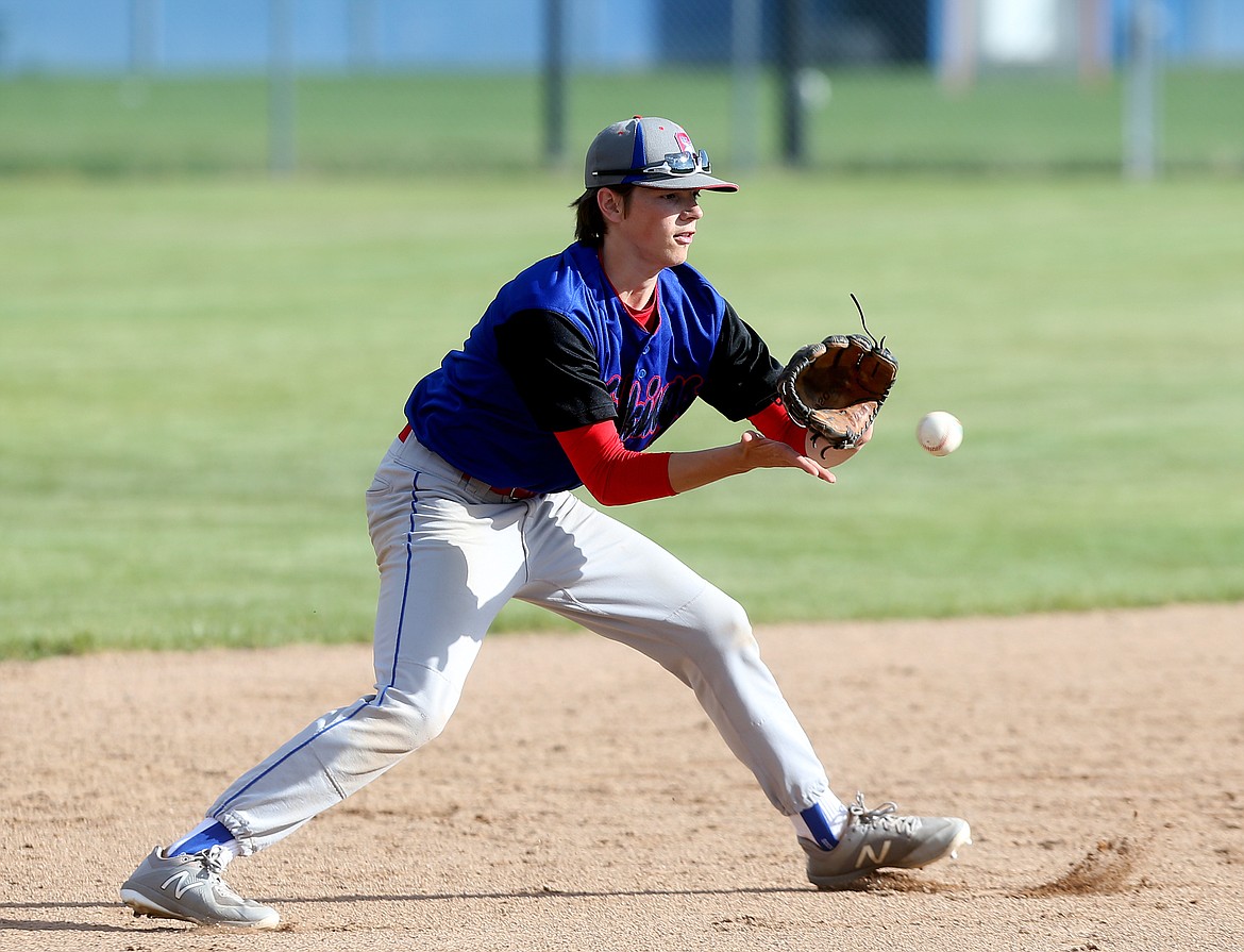 Coeur d&#146;Alene shortstop Quinton Bunch fields a high bouncing ground ball in the 5A Region 1 championship game against Lewiston Tuesday at Coeur d&#146;Alene High School. (LOREN BENOIT/Press)