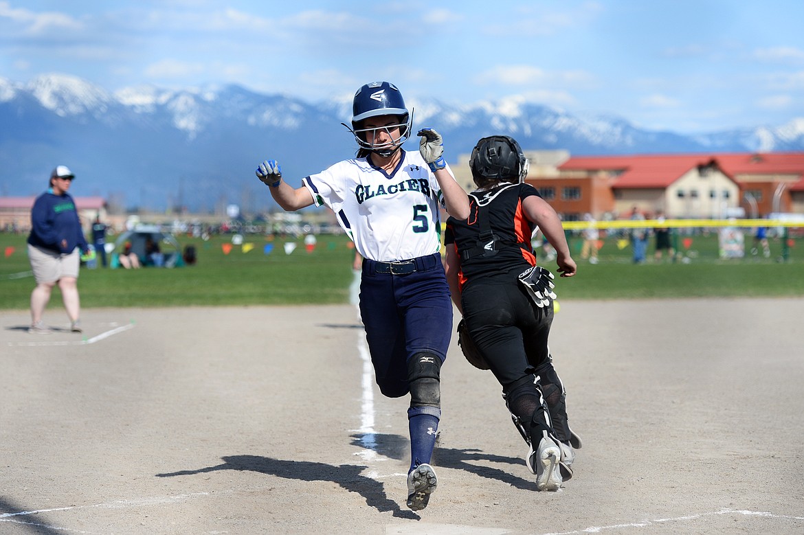 Glacier's Kenna Vanorny scores on a sacrifice fly by Addie Labrum in the bottom of the first against Flathead at Glacier High School on Thursday. (Casey Kreider/Daily Inter Lake)