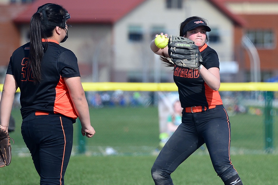 Flathead shortstop Riley Chouinard holds her throw to first after Glacier's Allee Meyer legged out an infield single in the bottom of the third at Glacier High School on Thursday. (Casey Kreider/Daily Inter Lake)