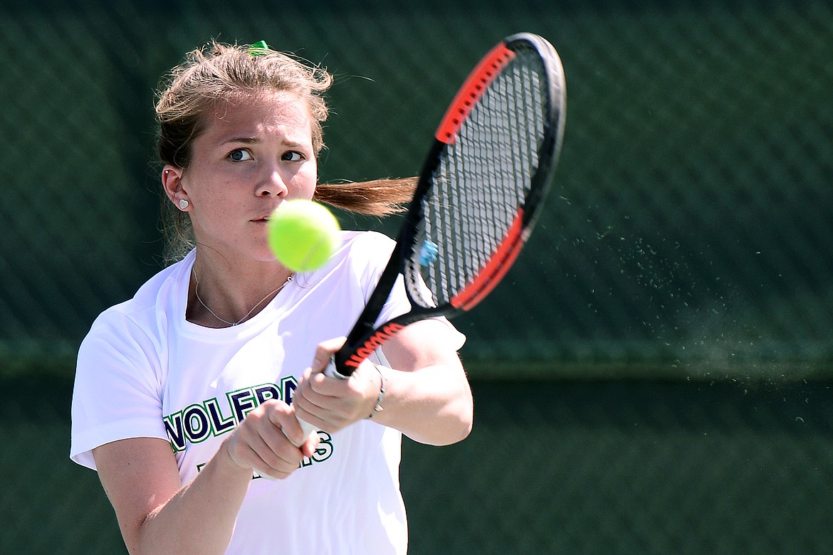 Glacier's Maria Frampton hits a backhand return against Flathead's Mason Moore at AA Divisionals at Flathead Valley Community College on Thursday. (Casey Kreider/Daily Inter Lake)