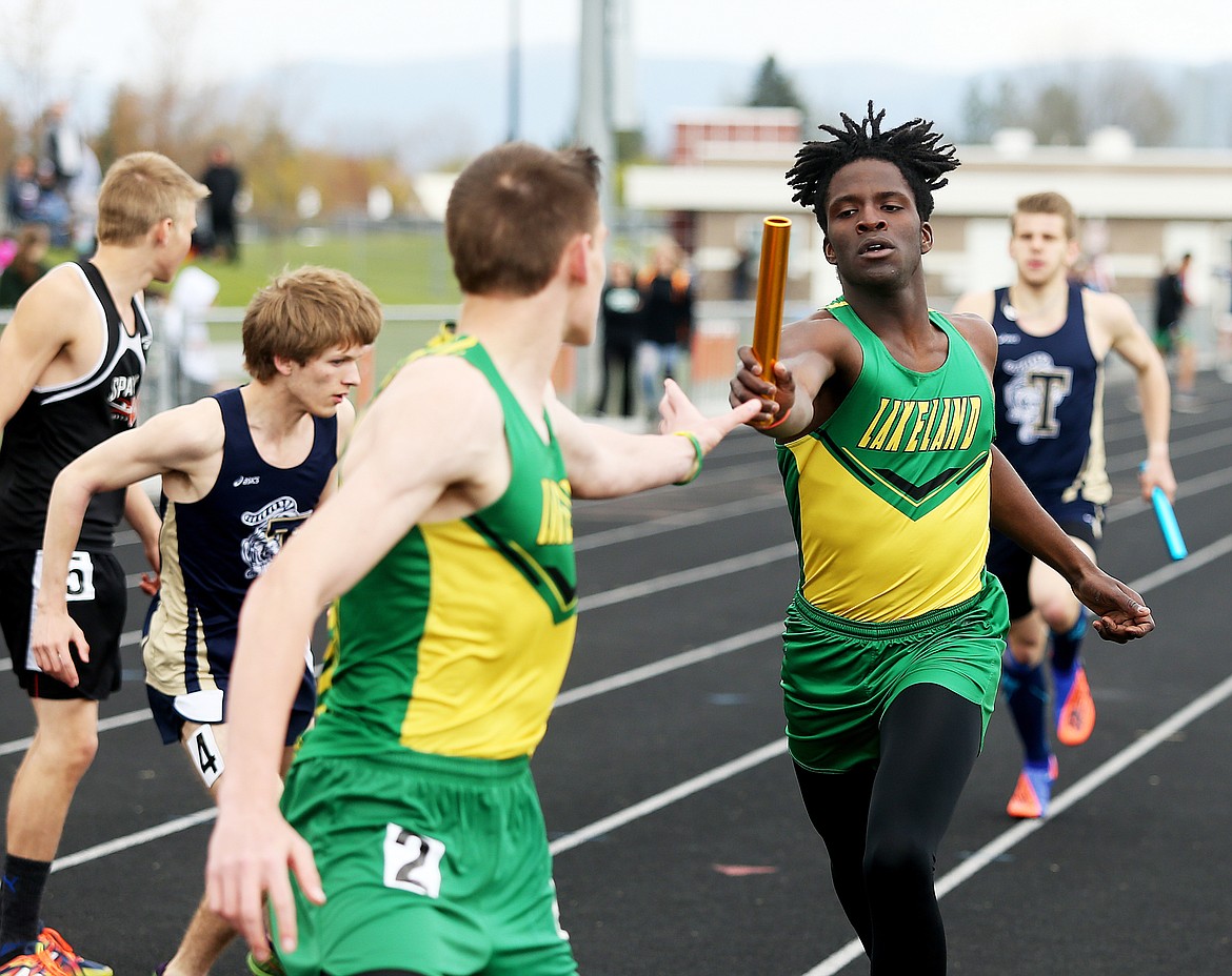 Lakeland High&#146;s Trey McArthur passes the baton to Neil Huber in the 1600 sprint medley at the District 1 All-Star Meet Thursday at Post Falls High School. (LOREN BENOIT/press)