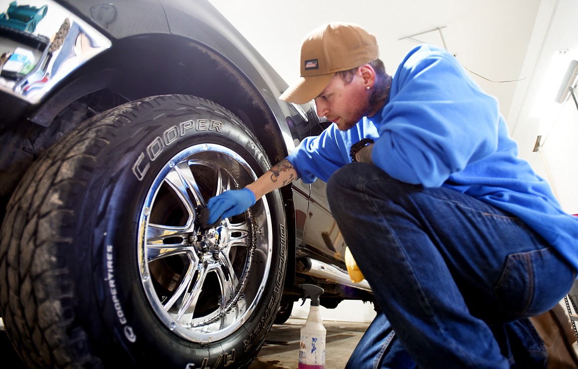 Michael Odom details a truck.