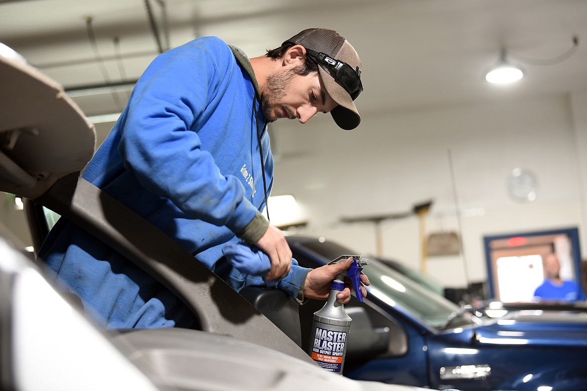 Michael Dalton cleans a vehicle carefully before beginning to install a new windshield at Grime to Shine.