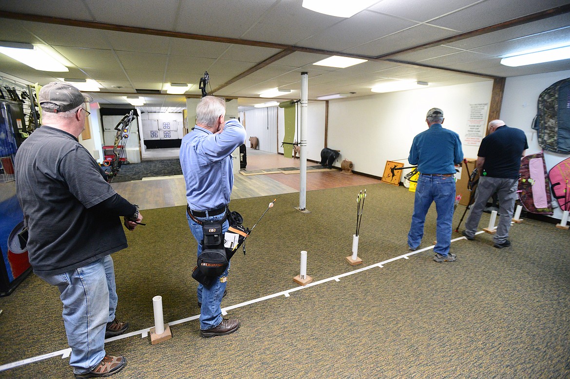 Archers practice at the range inside Flaming Arrow Archery in Evergreen.