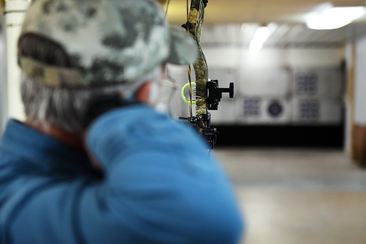 Kalispell resident Bob Howard nocks an arrow at the range inside Flaming Arrow Archery.