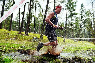 A competitor splashes through a swampy section of the 13-mile Spartan Beast race at Flathead Lake Lodge in Bigfork on Saturday. (Casey Kreider/Daily Inter Lake)