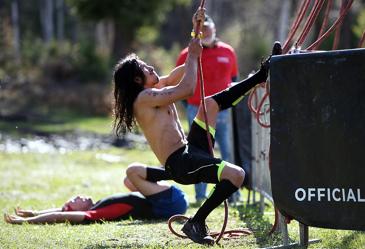 Competitors perform the Hercules Hoist during the 13-mile Spartan Beast race at Flathead Lake Lodge in Bigfork on Saturday. (Casey Kreider/Daily Inter Lake)