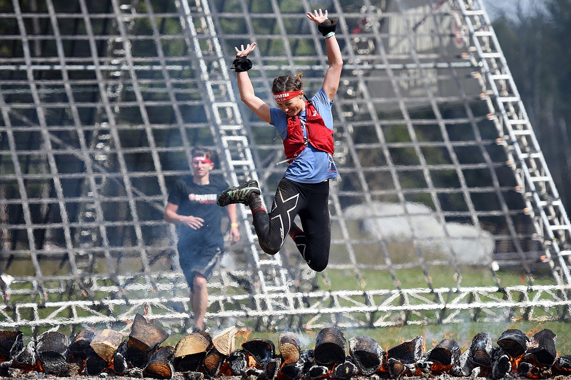 Sonya Elias, from Calgary, leaps over the finish line of the 13-mile Spartan Beast race at Flathead Lake Lodge in Bigfork on Saturday. (Casey Kreider/Daily Inter Lake)