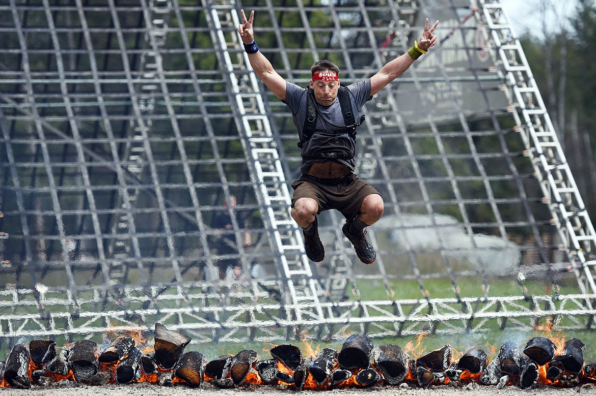 A competitor leaps over the finish line of the 13-mile Spartan Beast race at Flathead Lake Lodge in Bigfork on Saturday. (Casey Kreider/Daily Inter Lake)