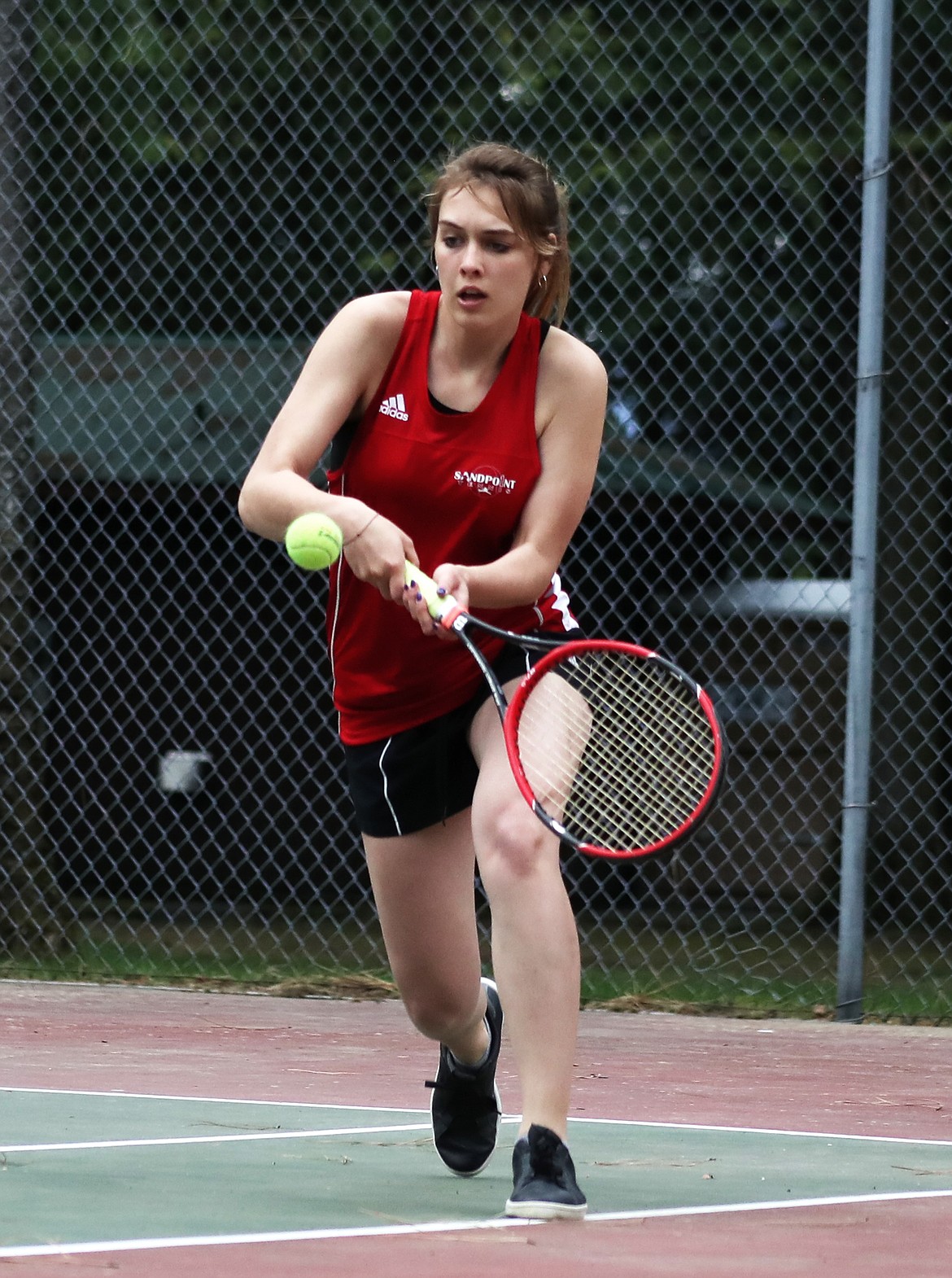 (Photo by KYLE CAJERO) Sandpoint senior Colleene McBride prepares to hit a backhand during her singles match against Post Falls&#146; Charlie Bastedo on May 1.