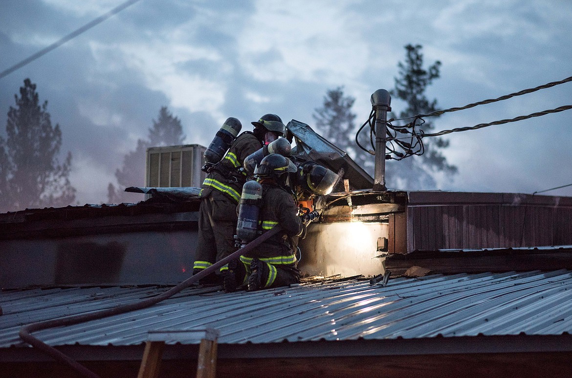 Fire crews attempt to extinguish a fire inside of Moody&#146;s Dirty Laundry &amp; Self-Service Dog Wash, Thursday night in Libby. (Luke Hollister/The Western News)
