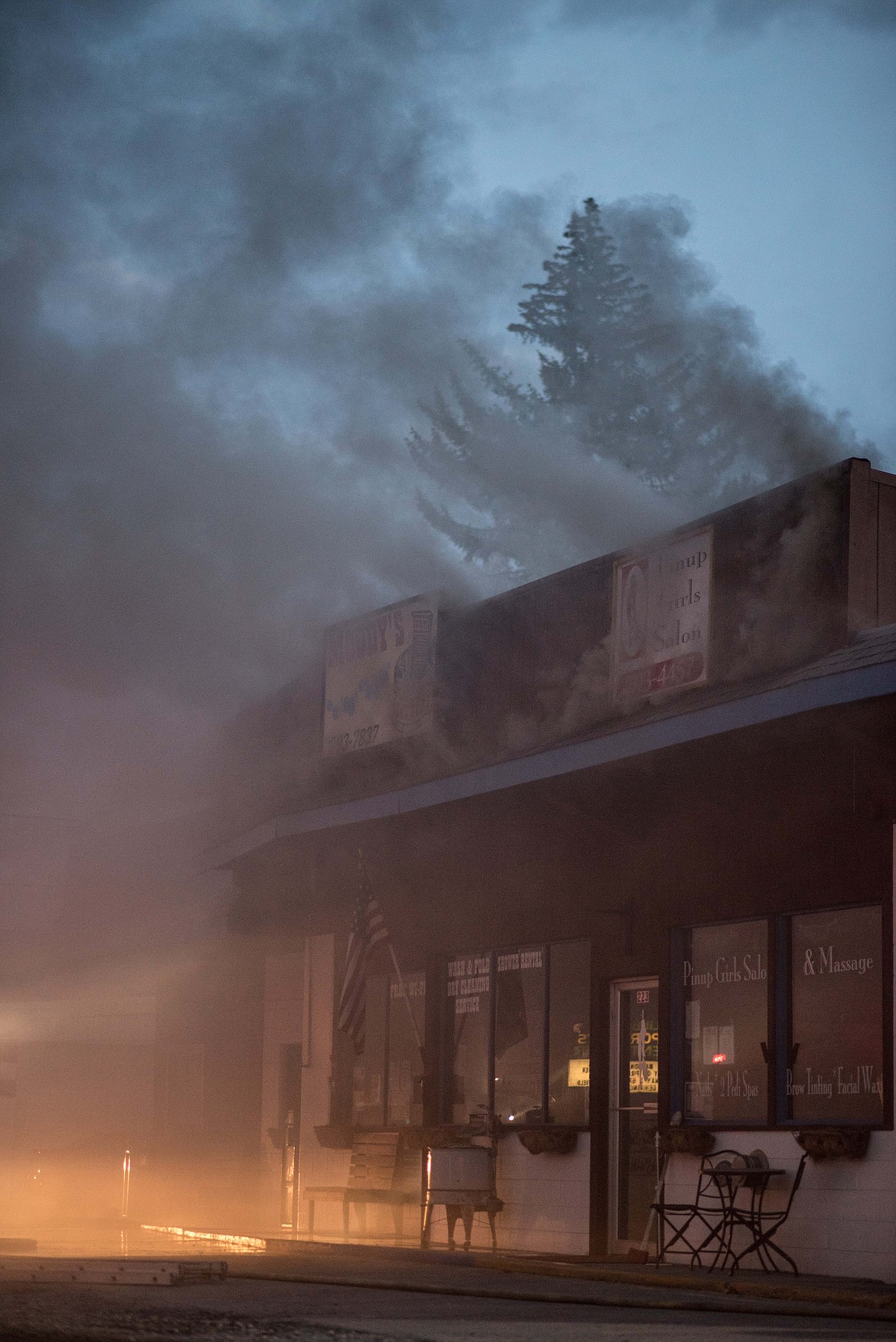 Smoke rises from the roof of Moody&#146;s Dirty Laundry &amp; Self-Service Dog Wash from a fire, Friday night in Libby. (Luke Hollister/The Western News)