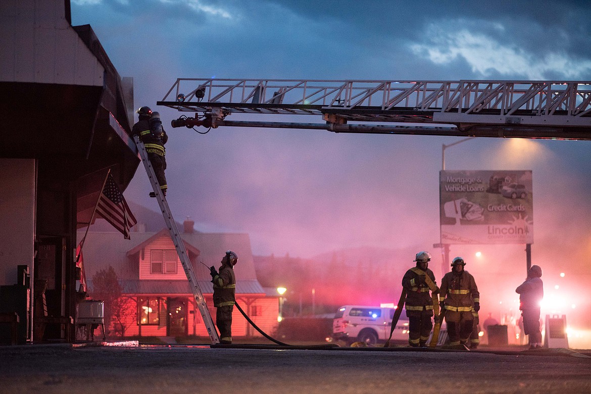 Fire crews tear off parts of the roof while attempting to access a fire inside of Moody&#146;s Dirty Laundry &amp; Self-Service Dog Wash, Friday night in Libby. (Luke Hollister/The Western News)